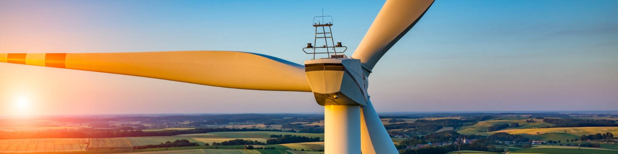 Renewable energy being produced by wind turbines at sunset